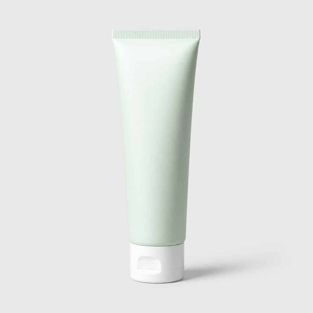 Tube de crème apaisante posé sur fond neutre clair