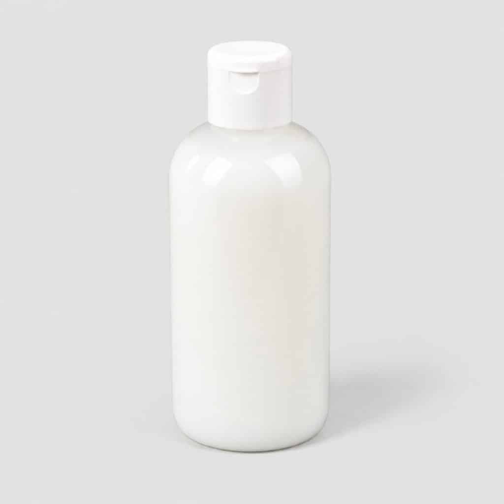 Flacon de liniment oléo-calcaire posé sur fond neutre